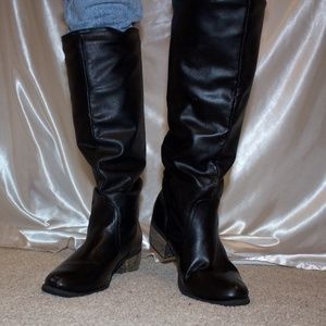 Tall black faux leather boots